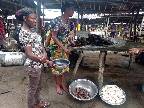 Miss Blessing exchanging cassava for fish