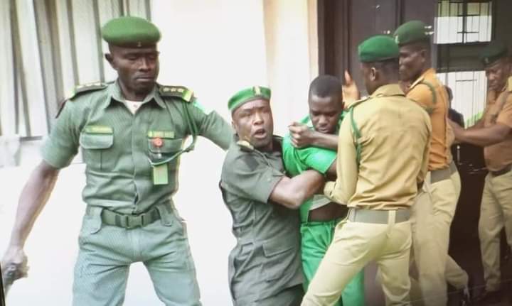 Uduak Akpan being led out of the courtroom by armed security operatives