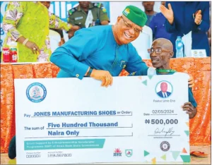 Person with special ability, Jones Akpan receives cheque from Umo Eno